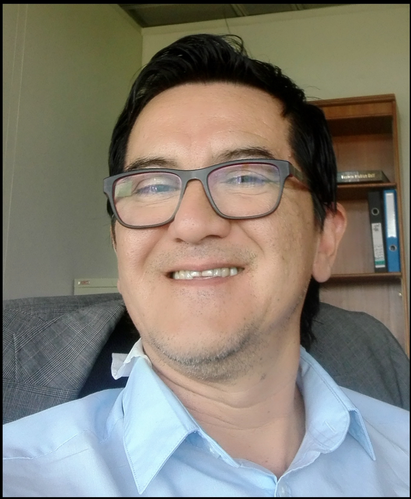 A person wearing glasses and smiling

AI-generated content may be incorrect.