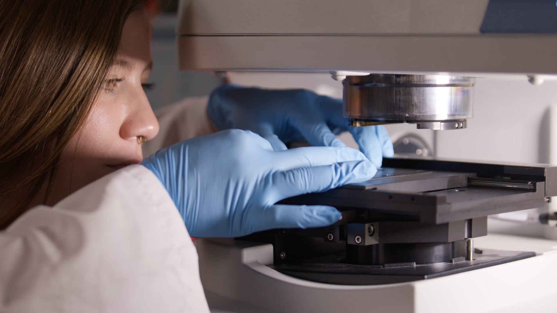 Researcher working with sample under the microscope